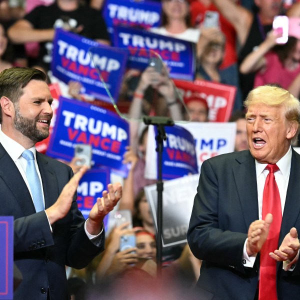 Donald Trump and JD Vance clap at a Grand Rapids, Michigan, rally on July 20, 2024.