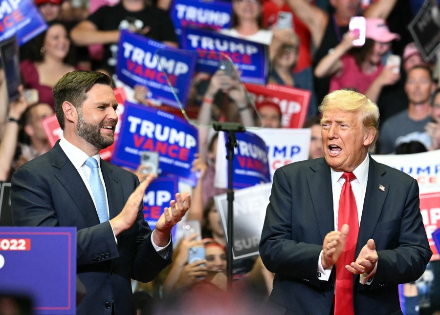 Donald Trump and JD Vance clap at a Grand Rapids, Michigan, rally on July 20, 2024.