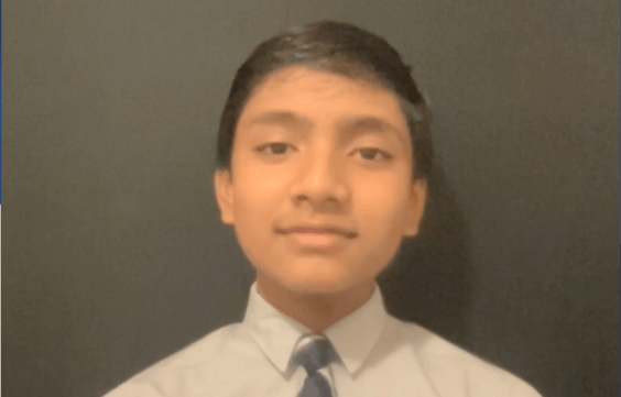 12-year-old Subarno Isaac Bari sits in front of a black background.