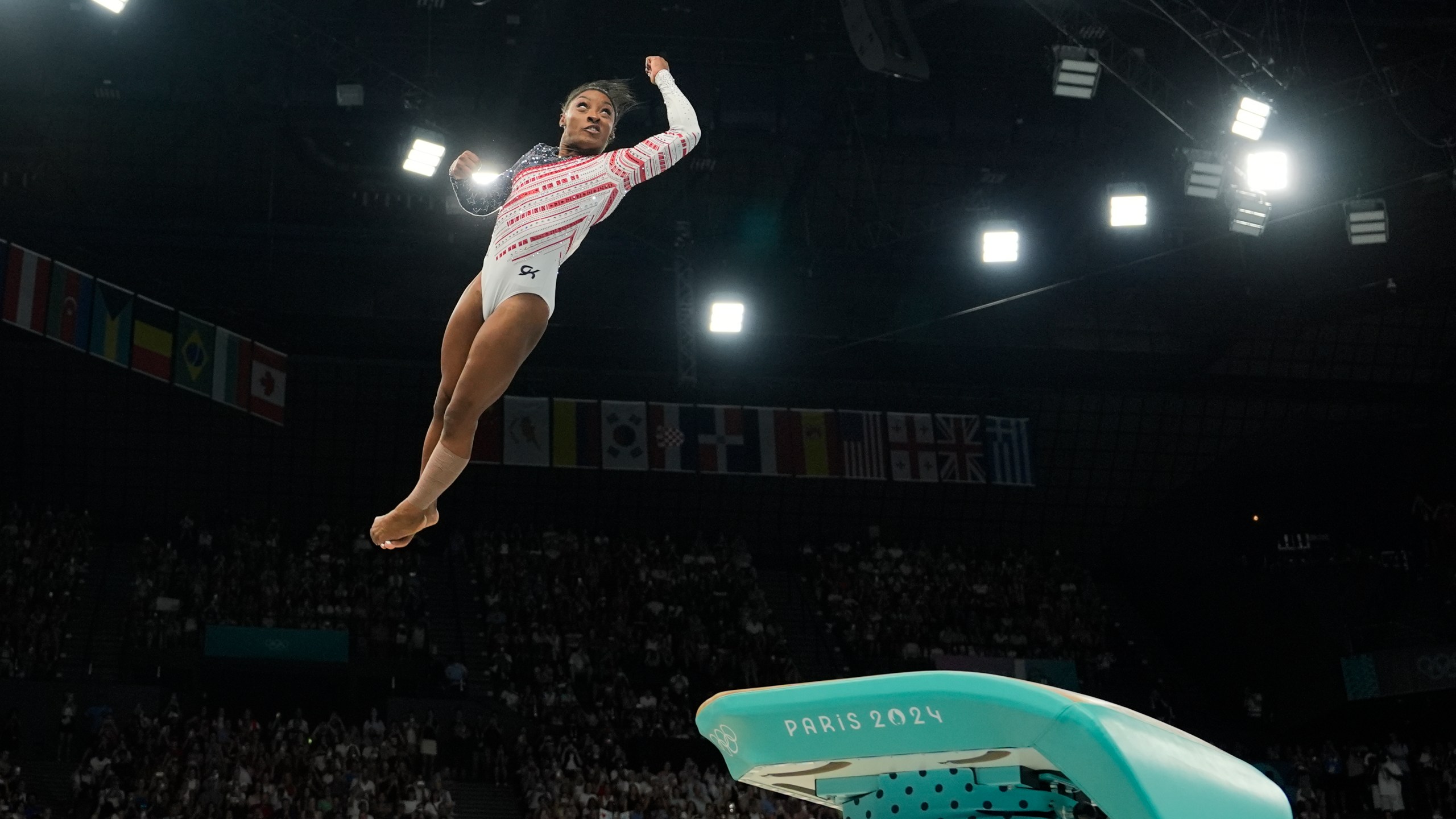 Simone Biles, of the United States, performs on the vault during the women's artistic gymnastics team finals round at Bercy Arena at the 2024 Summer Olympics, Tuesday, July 30, 2024, in Paris, France. (AP Photo/Charlie Riedel)