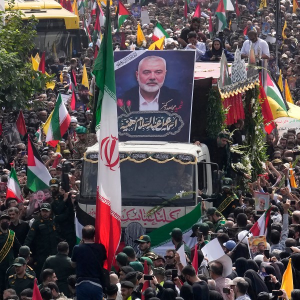 Iranians follow a truck, center, carrying the coffins of Hamas leader Ismail Haniyeh and his bodyguard who were killed in an assassination blamed on Israel on Wednesday, during their funeral ceremony at Enqelab-e-Eslami (Islamic Revolution) Sq. in Tehran, Iran, Thursday, Aug. 1, 2024. (AP Photo/Vahid Salemi)