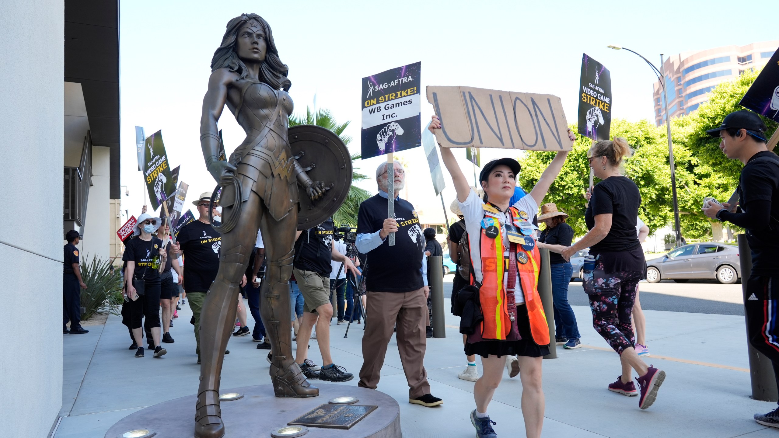 XXX participates in a kick-off picket line for the SAG-AFTRA video game strike at Warner Bros. Games headquarters on Thursday, Aug. 1, 2024, in Burbank, Calif. Hollywood's video game performers are currently on strike, throwing part of the entertainment industry into another work stoppage after talks for a new contract with major game studios broke down over artificial intelligence protections. (AP Photo/Chris Pizzello)