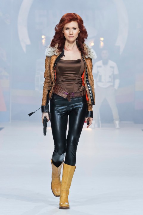 FILE - Anna Chapman, who was deported from the U.S. on charges of espionage, displays a creation by Russian designers Shiyan & Rudkovskaya during a Fashion Week in Moscow, Russia on Sunday, April 3, 2011. In June 2010, U.S. officials rounded up 10 Russians, including Chapman, alleged to be "sleeper agents" — living under false identities without specific espionage missions — to be activated as needed. They were exchanged for four people imprisoned in Russia. (AP Photo /Luba Sheme, File)