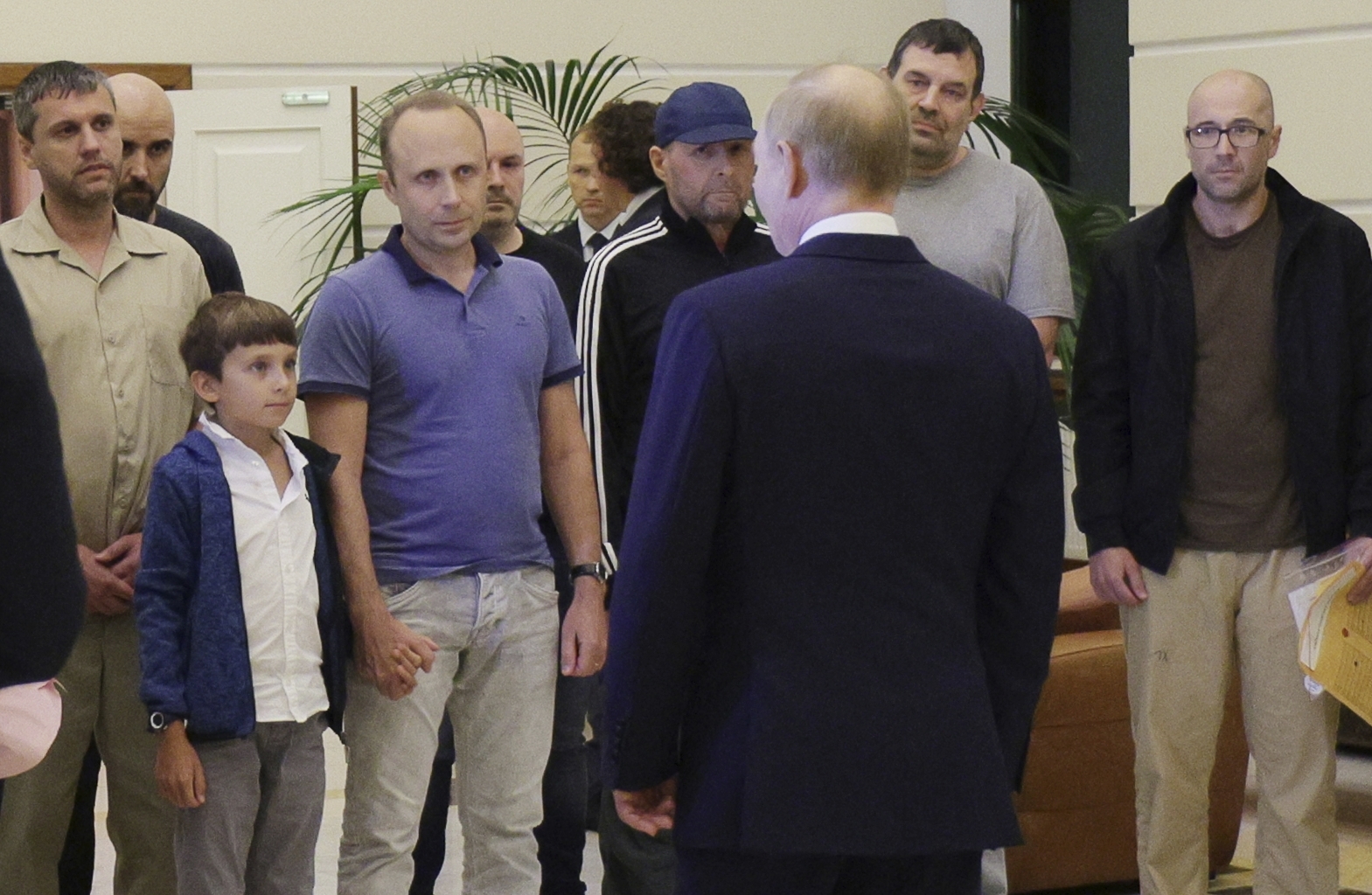 Russian President Vladimir Putin, front, greets released Russian prisoners and relatives at the government terminal of the Vnukovo airport in Moscow, Russia, Aug. 1, 2024. (Gavriil Grigorov, Sputnik, Kremlin Pool Photo via AP)