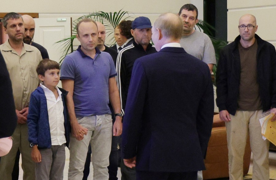 Russian President Vladimir Putin, front, greets released Russian prisoners and relatives at the government terminal of the Vnukovo airport in Moscow, Russia, Aug. 1, 2024. (Gavriil Grigorov, Sputnik, Kremlin Pool Photo via AP)