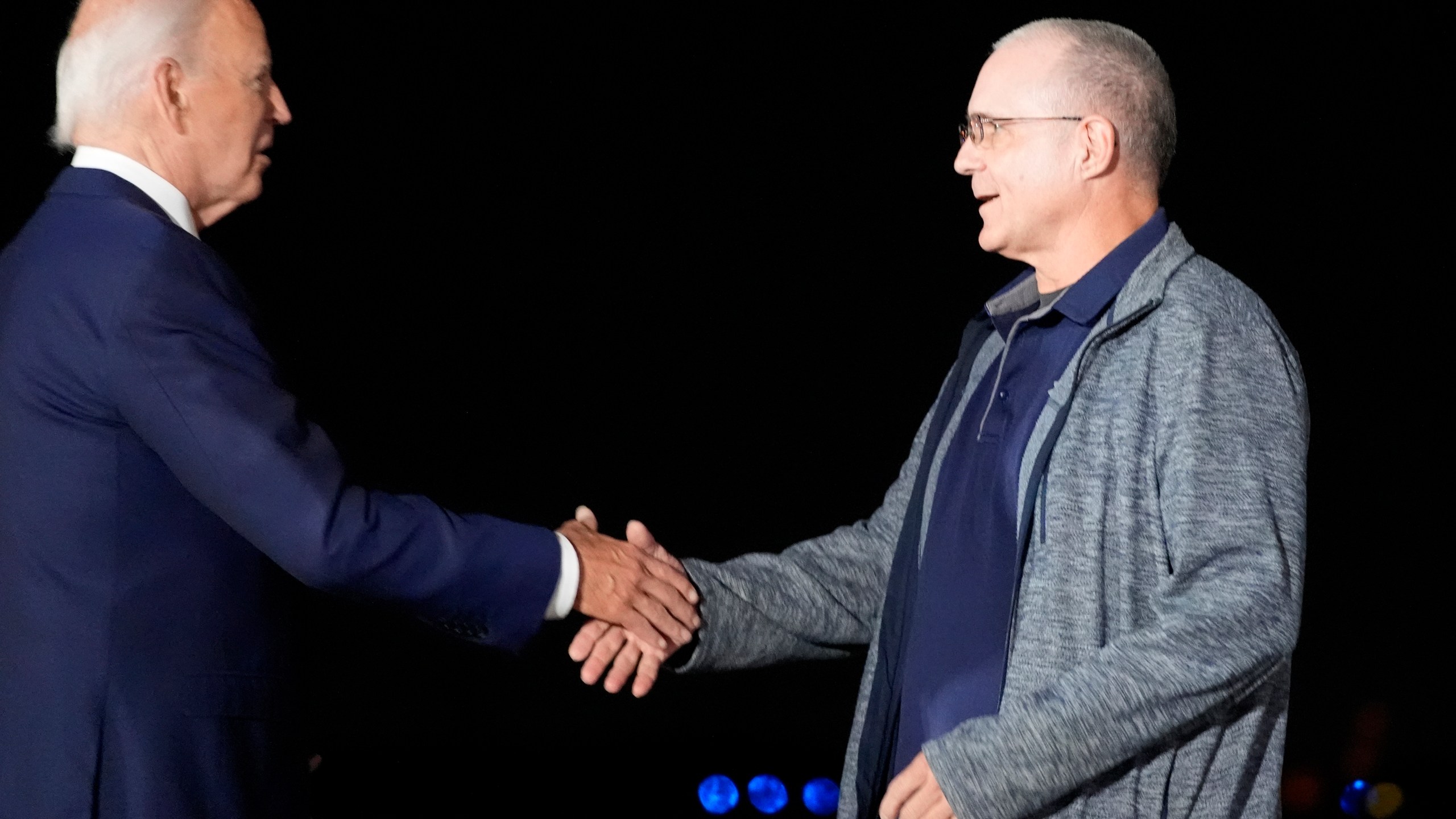 President Joe Biden, left, greets Paul Whelan at Andrews Air Force Base, Md., following his release as part of a 24-person prisoner swap between Russia and the United States, Thursday, Aug. 1, 2024. (AP Photo/Alex Brandon)