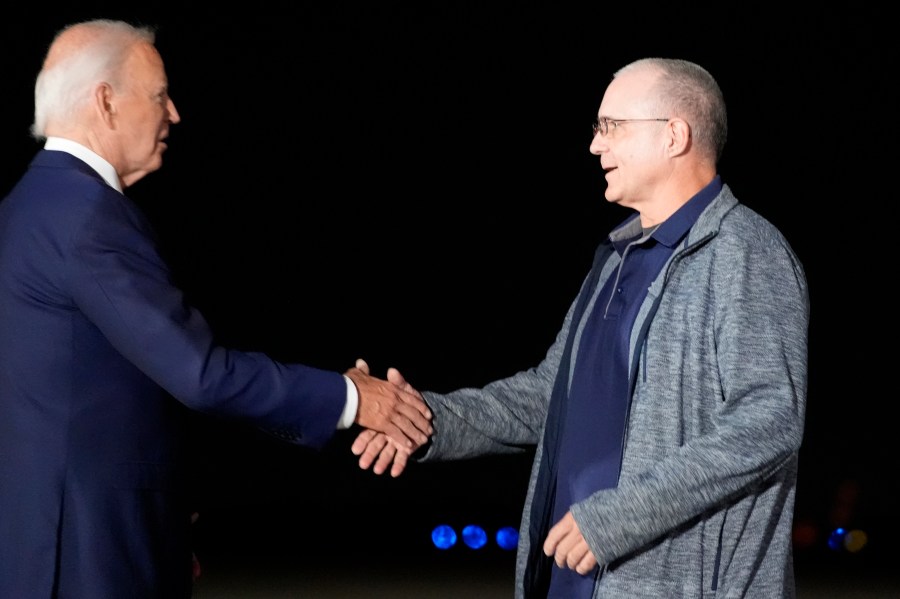 President Joe Biden, left, greets Paul Whelan at Andrews Air Force Base, Md., following his release as part of a 24-person prisoner swap between Russia and the United States, Thursday, Aug. 1, 2024. (AP Photo/Alex Brandon)