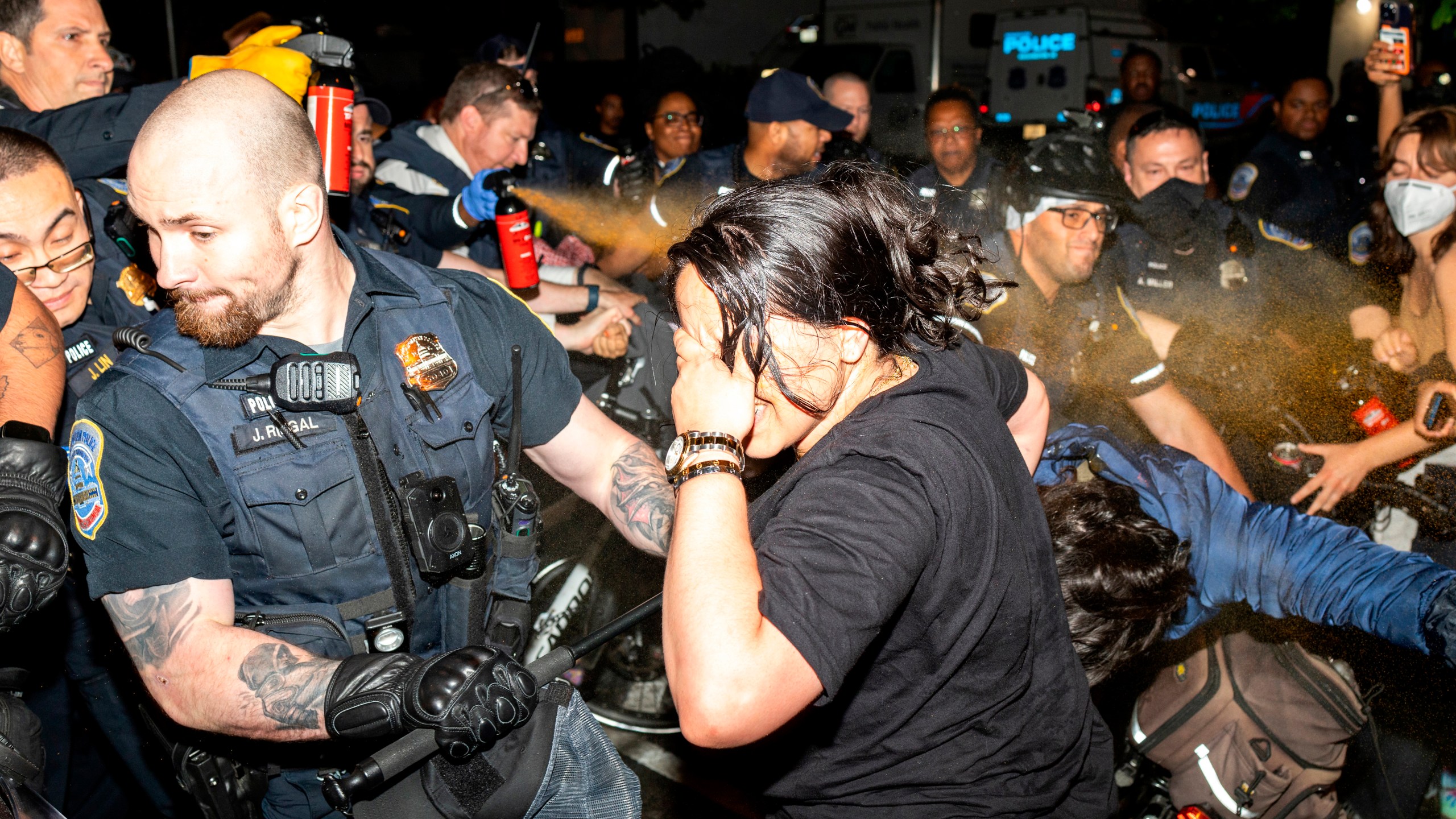 FILE - Officers of the Metropolitan Police Department pepper spray demonstrators at George Washington University in Washington, May 8, 2024. More than 3,200 people were arrested on campuses this spring during a wave of pro-Palestinian tent encampments protesting the war in Gaza. (Sage Russell/GW Hatchet via AP, File)