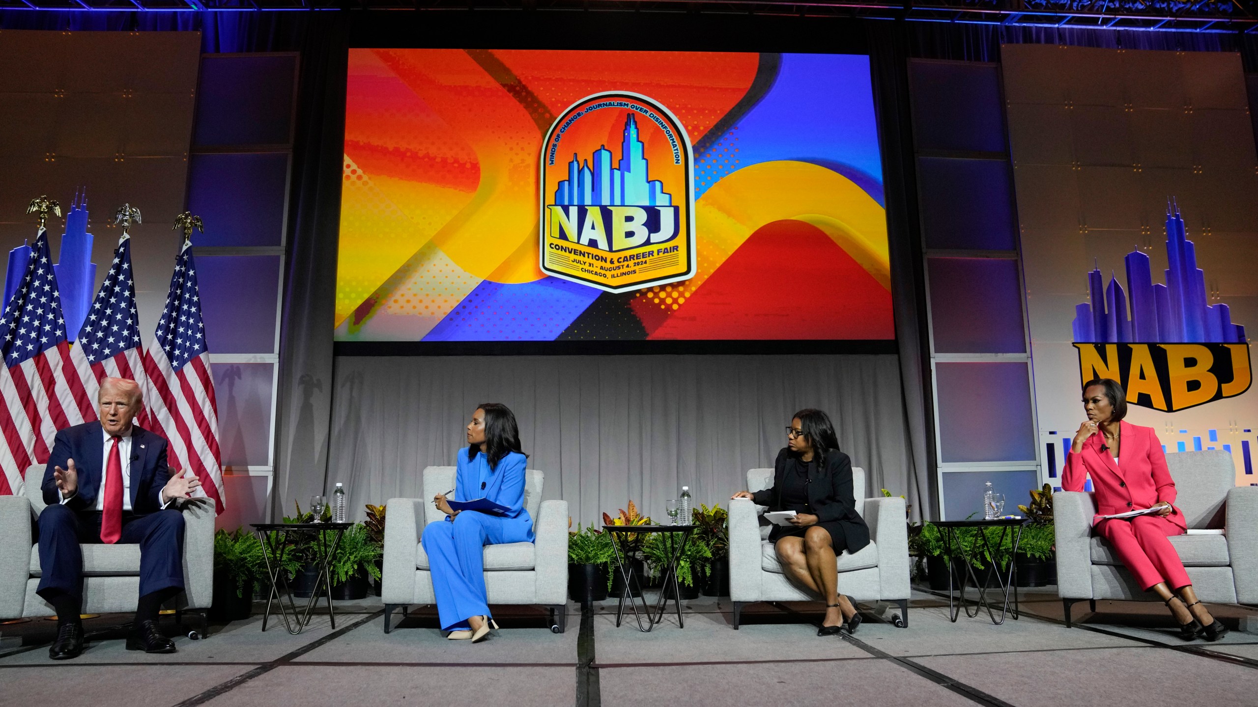 Republican presidential candidate former President Donald Trump, left, moderated by from left, ABC's Rachel Scott, Semafor's Nadia Goba and FOX News' Harris Faulkner, speaks at the National Association of Black Journalists, NABJ, convention, Wednesday, July 31, 2024, in Chicago. (AP Photo/Charles Rex Arbogast)