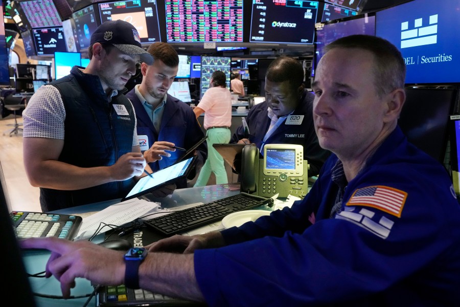 Traders gather at the post of specialist Stephen Naughton, right,on the floor of the New York Stock Exchange, Friday, Aug. 2, 2024. (AP Photo/Richard Drew)