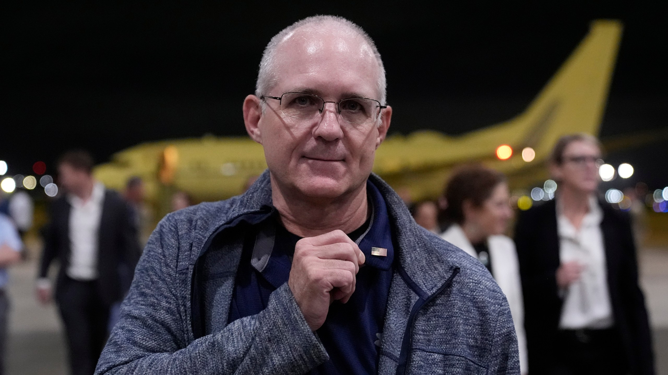 Paul Whelan shows a pin he received from President Joe Biden as he arrives at Kelly Field after being released by Russia, Friday, Aug. 2, 2024, in San Antonio. (AP Photo/Eric Gay)