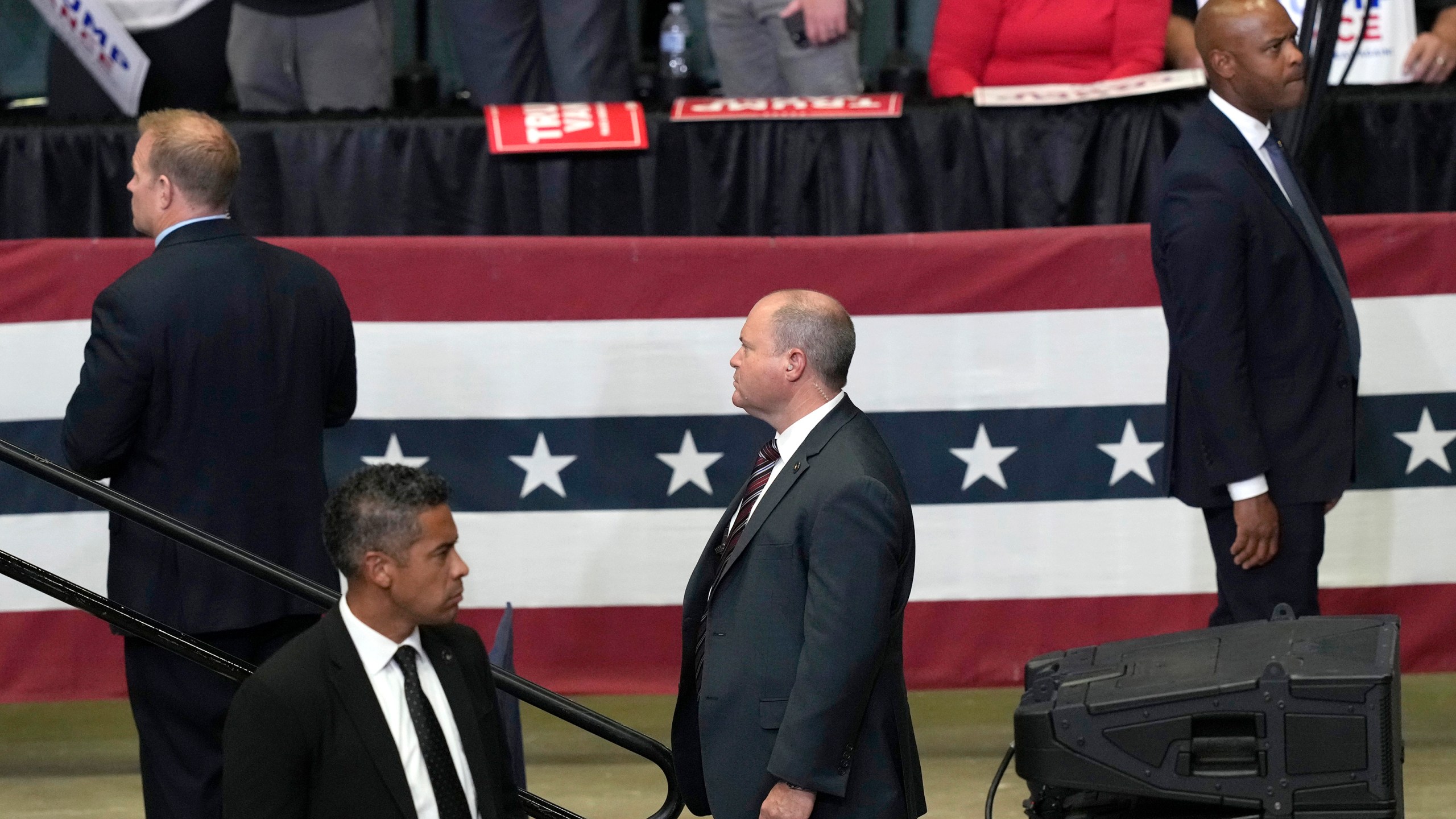 FILE - Members of the Secret Service look on as Republican presidential candidate former President Donald Trump speaks at a campaign event, July 20, 2024, in Grand Rapids, Mich. Few Americans have high confidence in the Secret Service's ability to keep presidential candidates safe after last month's attempt on Trump's life. That is according to a new poll conducted July 25-29, from the AP-NORC Center for Public Affairs Research. Only around three in 10 Americans are extremely or very confident that the Secret Service can keep the presidential candidates safe from violence before the election. (AP Photo/Carlos Osorio, File)