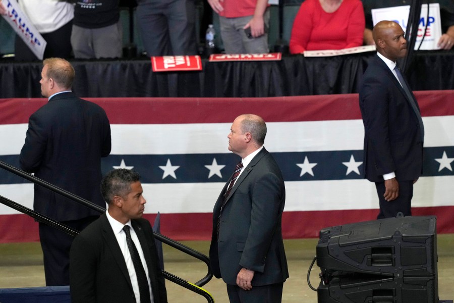 FILE - Members of the Secret Service look on as Republican presidential candidate former President Donald Trump speaks at a campaign event, July 20, 2024, in Grand Rapids, Mich. Few Americans have high confidence in the Secret Service's ability to keep presidential candidates safe after last month's attempt on Trump's life. That is according to a new poll conducted July 25-29, from the AP-NORC Center for Public Affairs Research. Only around three in 10 Americans are extremely or very confident that the Secret Service can keep the presidential candidates safe from violence before the election. (AP Photo/Carlos Osorio, File)