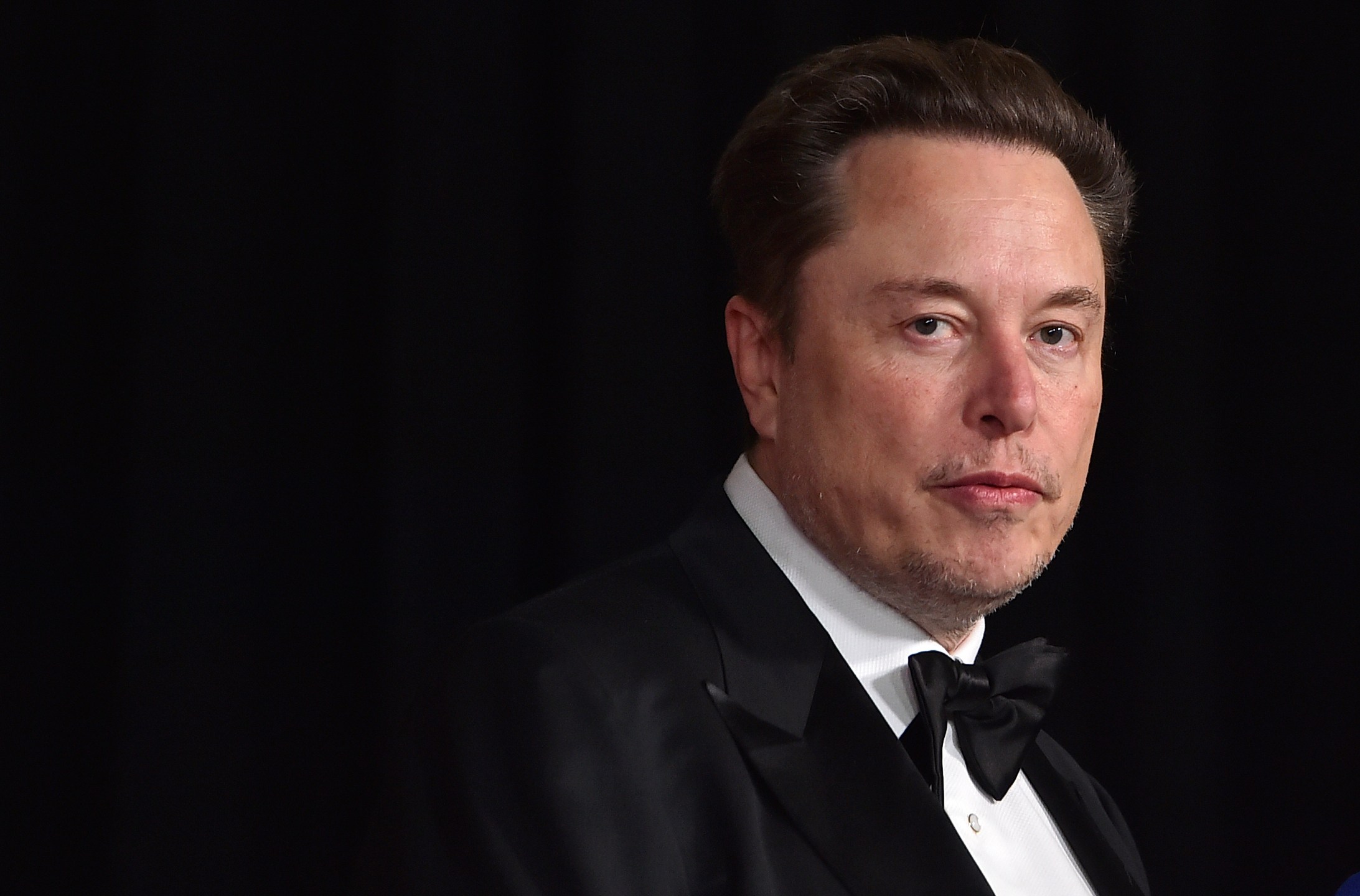 A picture of Elon Musk wearing a tuxedo.