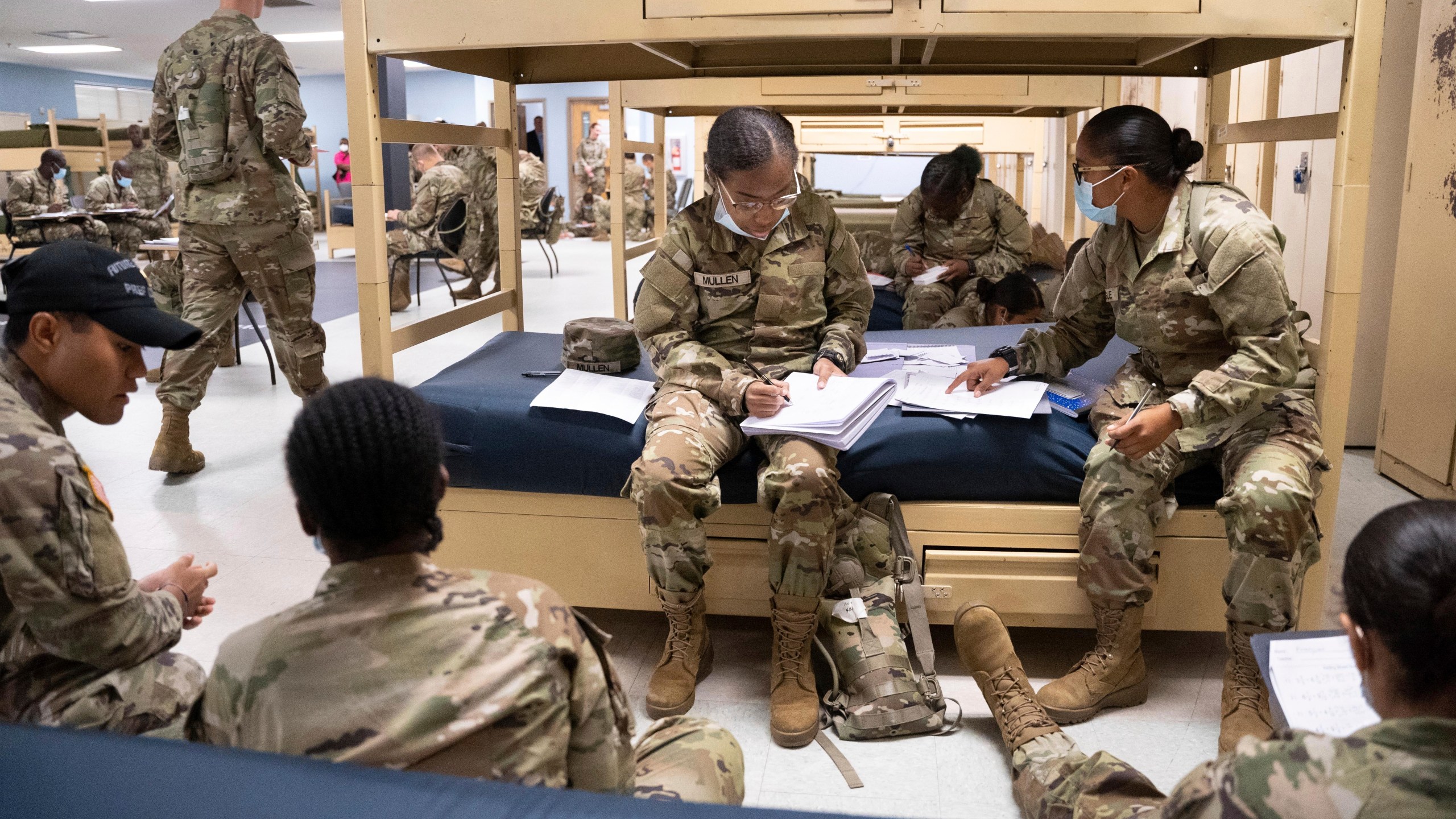 FILE - Students enlisted in the new Army prep course work together in barracks at Fort Jackson in Columbia, S.C., Aug. 26, 2022. The Army will expand its basic combat training for newly enlisted soldiers in what its leaders hope reflects a turning point as it prepares to meet the challenges of future wars. The added training will begin in October 2024 and comes as the Army works to reverse several years of dismal recruiting when it failed to meet its enlistment goals. (AP Photo/Sean Rayford, File)