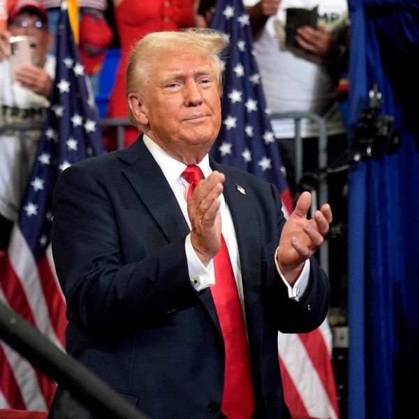 Republican presidential candidate former President Donald Trump claps at a campaign rally at Georgia State University in Atlanta, Saturday, Aug. 3, 2024. (AP Photo/John Bazemore)