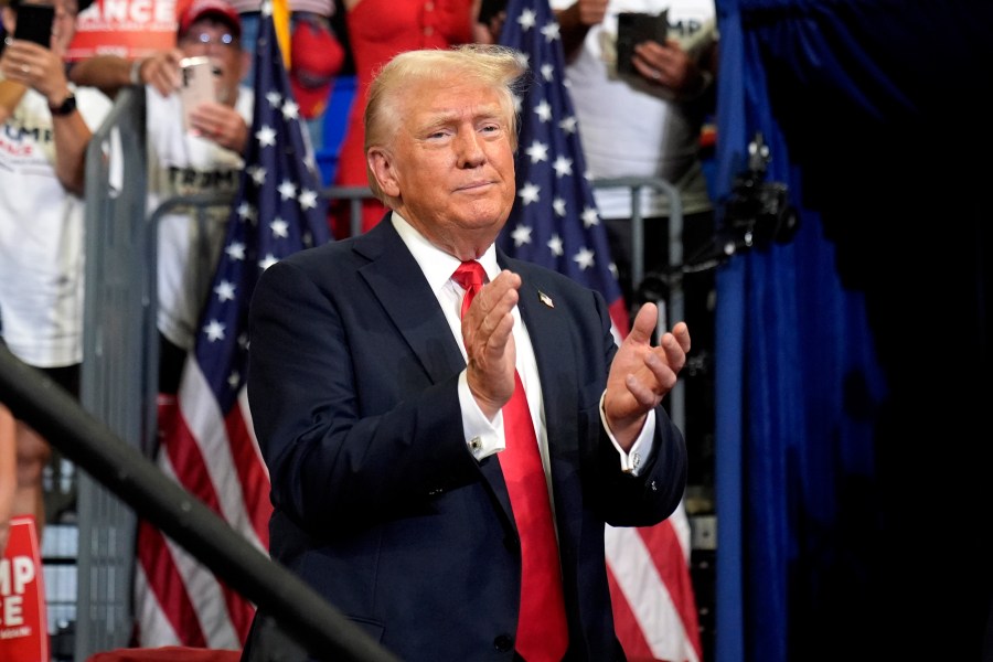 Republican presidential candidate former President Donald Trump claps at a campaign rally at Georgia State University in Atlanta, Saturday, Aug. 3, 2024. (AP Photo/John Bazemore)