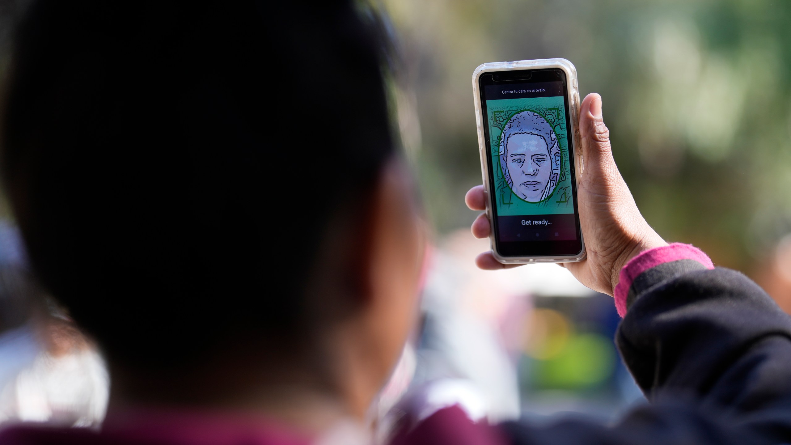 FILE - A migrant from Michoacan, Mexico, uses the CBPOne app Tuesday, Jan. 24, 2023, in Tijuana, Mexico. Migrants will be able to schedule appointments on the CBP One app from the states of Chiapas and Tabasco, extending the zone from northern and central Mexico, U.S. Customs and Border Protection said. The move satisfies a request of Mexico, an increasingly close partner of the U.S. in efforts to control extraordinary migration flows. (AP Photo/Gregory Bull, File)