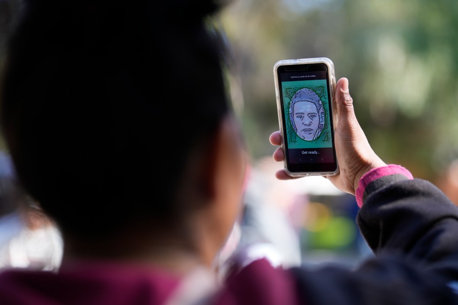 FILE - A migrant from Michoacan, Mexico, uses the CBPOne app Tuesday, Jan. 24, 2023, in Tijuana, Mexico. Migrants will be able to schedule appointments on the CBP One app from the states of Chiapas and Tabasco, extending the zone from northern and central Mexico, U.S. Customs and Border Protection said. The move satisfies a request of Mexico, an increasingly close partner of the U.S. in efforts to control extraordinary migration flows. (AP Photo/Gregory Bull, File)