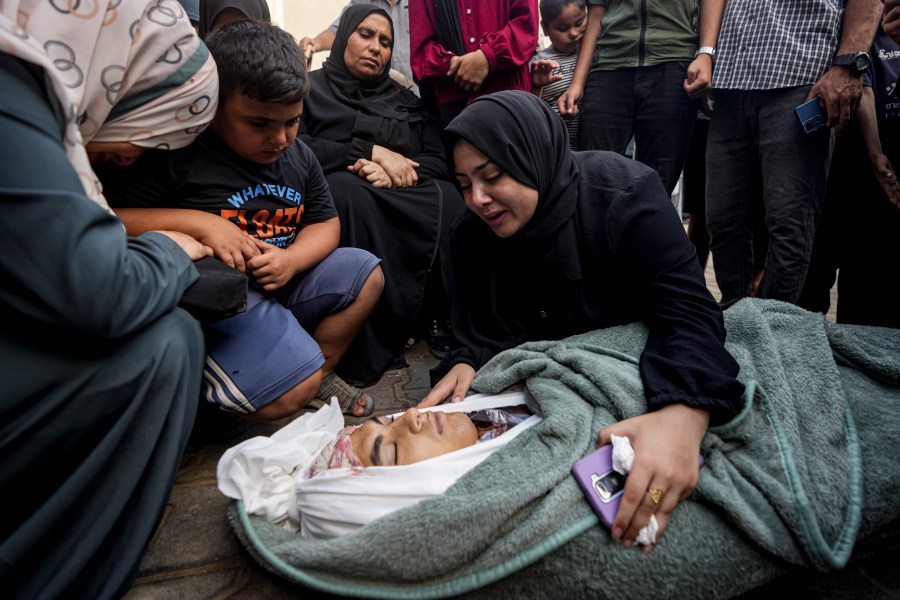 Palestinians mourn for a relative killed in the Israeli bombardment of the Gaza Strip, at a hospital in Deir al-Balah, Sunday, Aug. 4, 2024. (AP Photo/Abdel Kareem Hana)