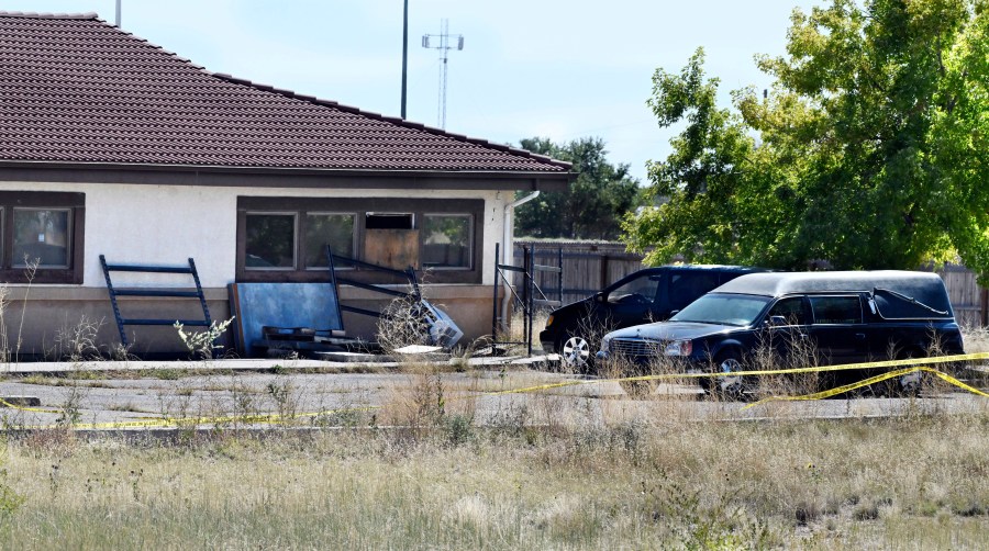 FILE - A hearse and debris sit behind the Return to Nature Funeral Home, Oct. 5, 2023, in Penrose, Colo. (Jerilee Bennett/The Gazette via AP, File)