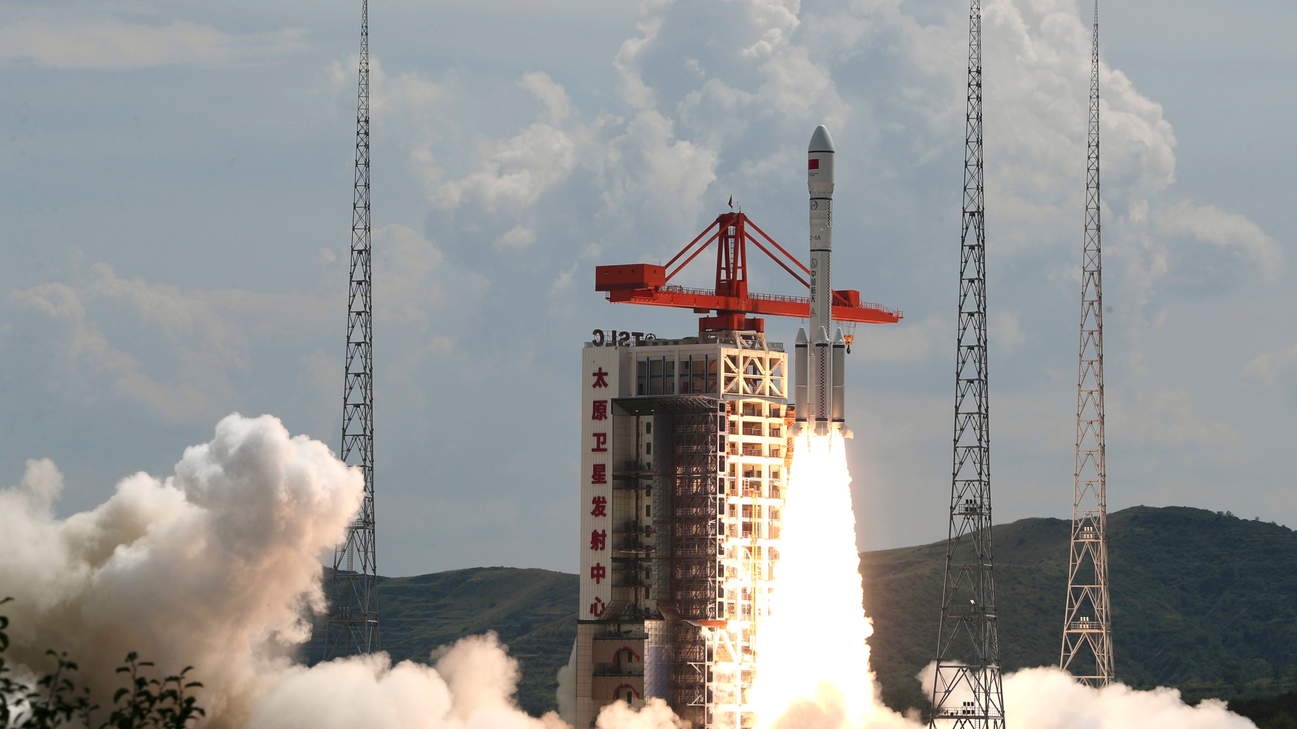 In this photo released by Xinhua News Agency, a modified Long March-6 carrier rocket carrying a new satellite group blasts off from the Taiyuan Satellite Launch Center in north China's Shanxi Province on Tuesday, Aug. 6, 2024. China says it launched the rocket Tuesday carrying a constellation of a reported 18 satellites as part of efforts to assert its presence in space. (Zheng Bin/Xinhua via AP)