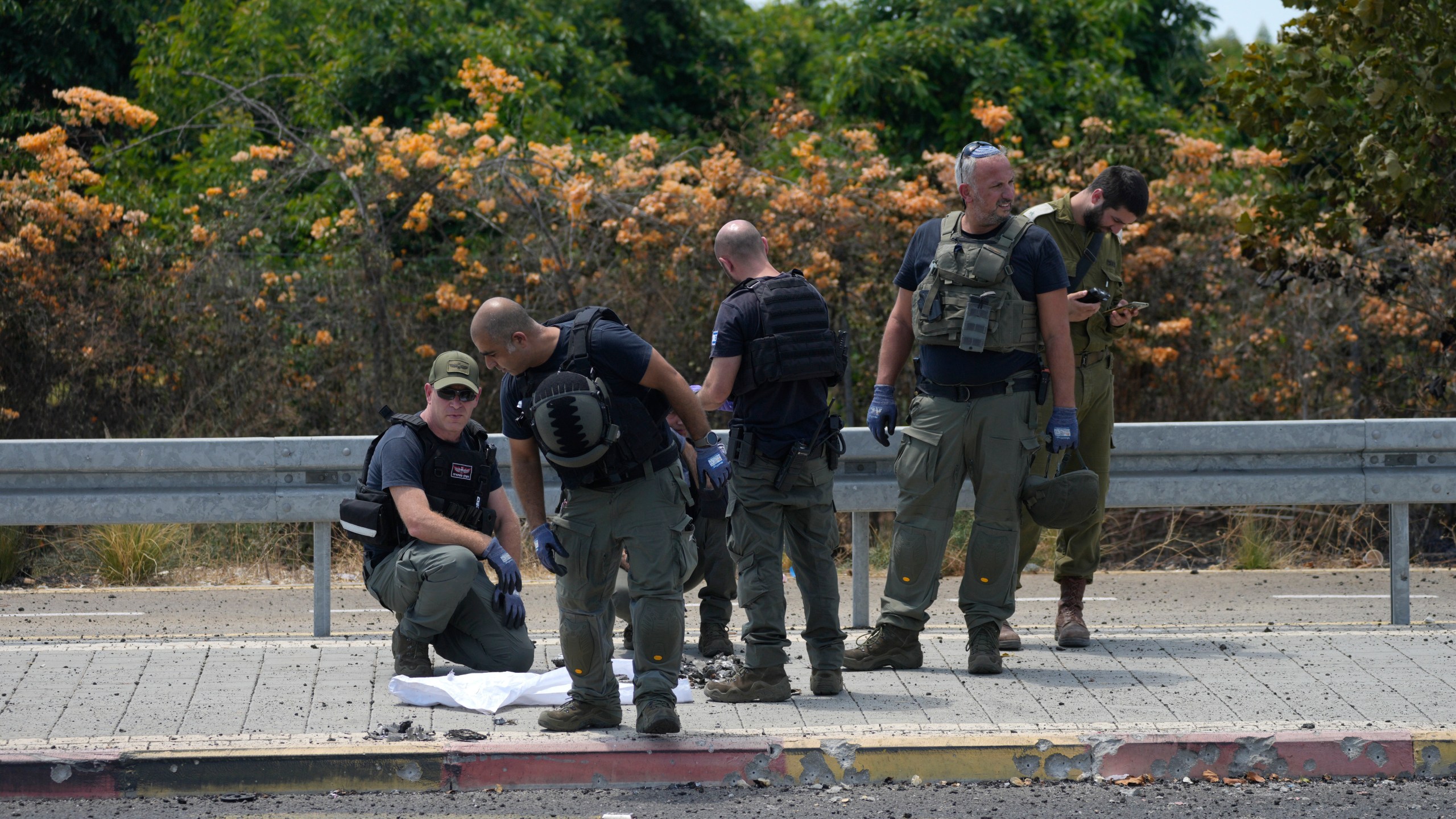 Israeli Police work at the site of a drone strike in Nahariya, Israel, Tuesday, Aug. 6, 2024. (AP Photo/Ohad Zwigenberg)