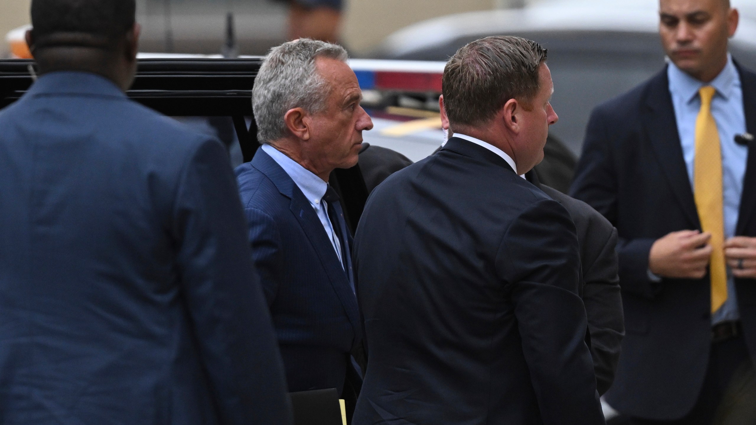 Independent presidential candidate Robert F. Kennedy Jr., second from left, arrives at the Albany County Courthouse to fight a lawsuit he falsely claimed to live in New York state, Tuesday, Aug. 6, 2024, in Albany, N.Y. (AP Photo/Hans Pennink)