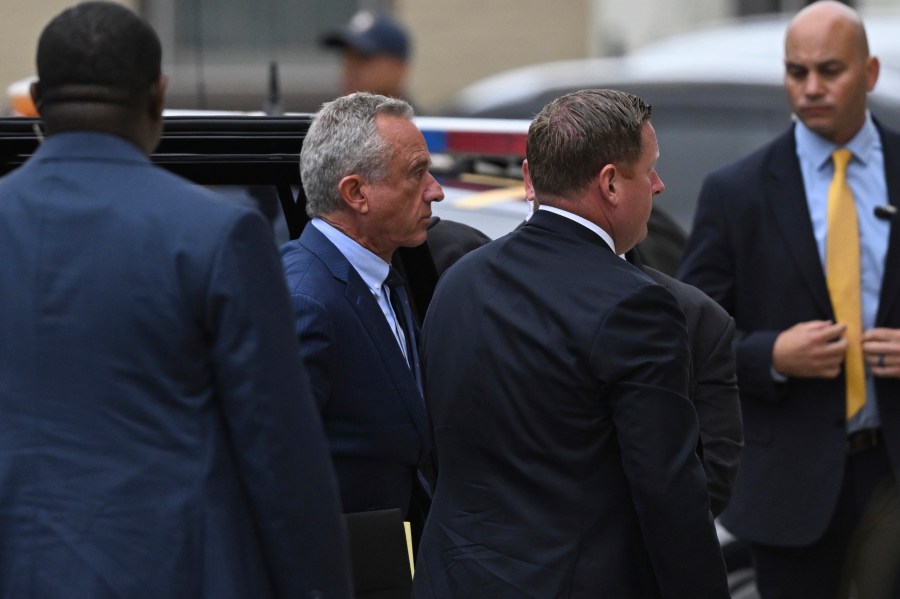 Independent presidential candidate Robert F. Kennedy Jr., second from left, arrives at the Albany County Courthouse to fight a lawsuit he falsely claimed to live in New York state, Tuesday, Aug. 6, 2024, in Albany, N.Y. (AP Photo/Hans Pennink)