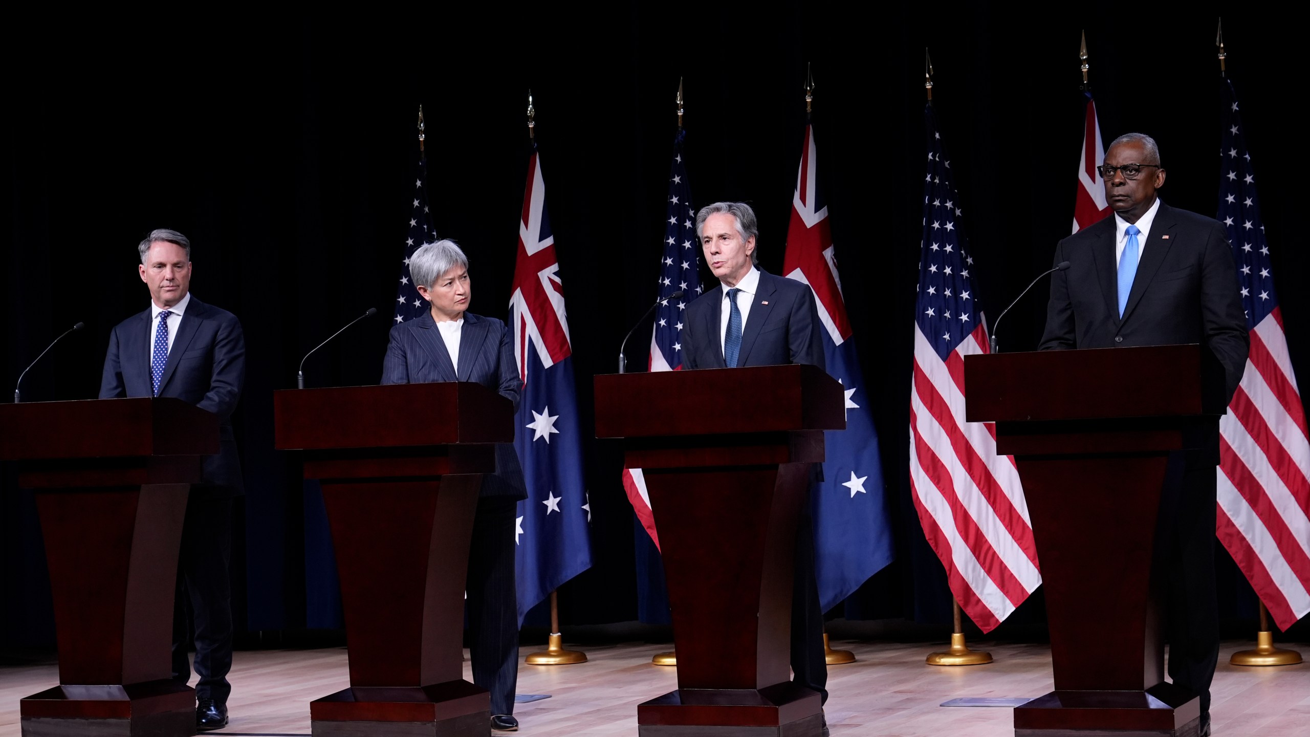 Secretary of State Antony Blinken, second from right, standing with, from left, Australia's Deputy Prime Minister and Defense Minister Richard Marles, Australia's Foreign Minister Penny Wong, and Defense Secretary Lloyd Austin, speaks during a news conference at the United States Naval Academy in Annapolis, Md., Tuesday, Aug. 6, 2024. (AP Photo/Susan Walsh)