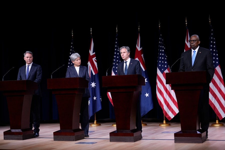 Secretary of State Antony Blinken, second from right, standing with, from left, Australia's Deputy Prime Minister and Defense Minister Richard Marles, Australia's Foreign Minister Penny Wong, and Defense Secretary Lloyd Austin, speaks during a news conference at the United States Naval Academy in Annapolis, Md., Tuesday, Aug. 6, 2024. (AP Photo/Susan Walsh)