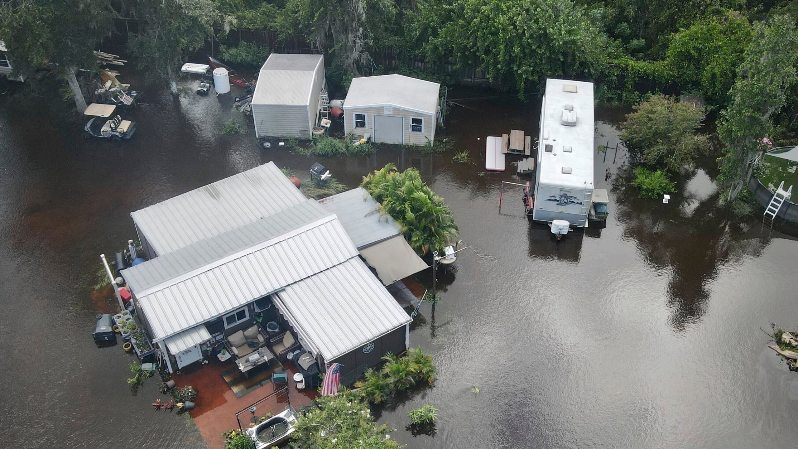 Bullfrog Creek, a tributary of the Alafie River, left some creekside homes inundated with floodwaters following Tropical Storm Debby, Tuesday, Aug. 6, 2024, in Alafia, Fla. (Max Chesnes/Tampa Bay Times via AP)