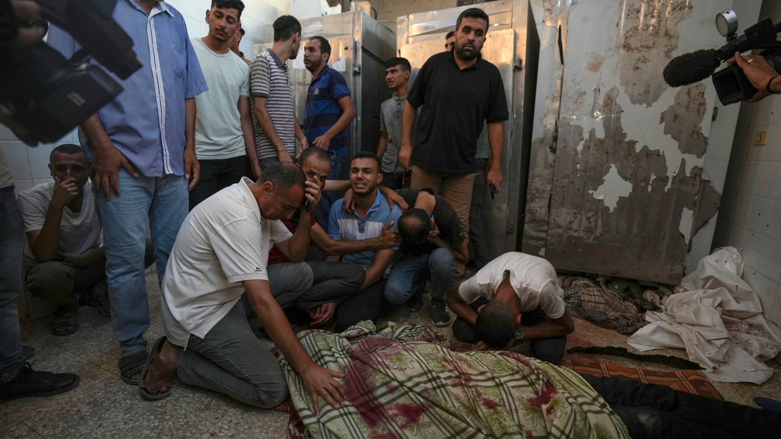 Palestinians mourn the victims of an Israeli airstrike in Deir al Balah, Gaza Strip, Tuesday, Aug. 6, 2024. (AP Photo/Abdel Kareem Hana)