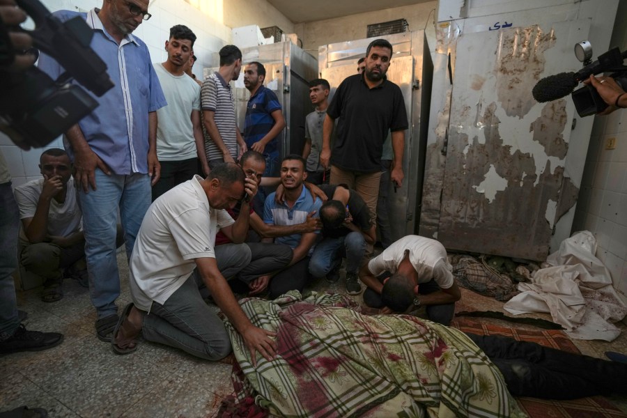 Palestinians mourn the victims of an Israeli airstrike in Deir al Balah, Gaza Strip, Tuesday, Aug. 6, 2024. (AP Photo/Abdel Kareem Hana)