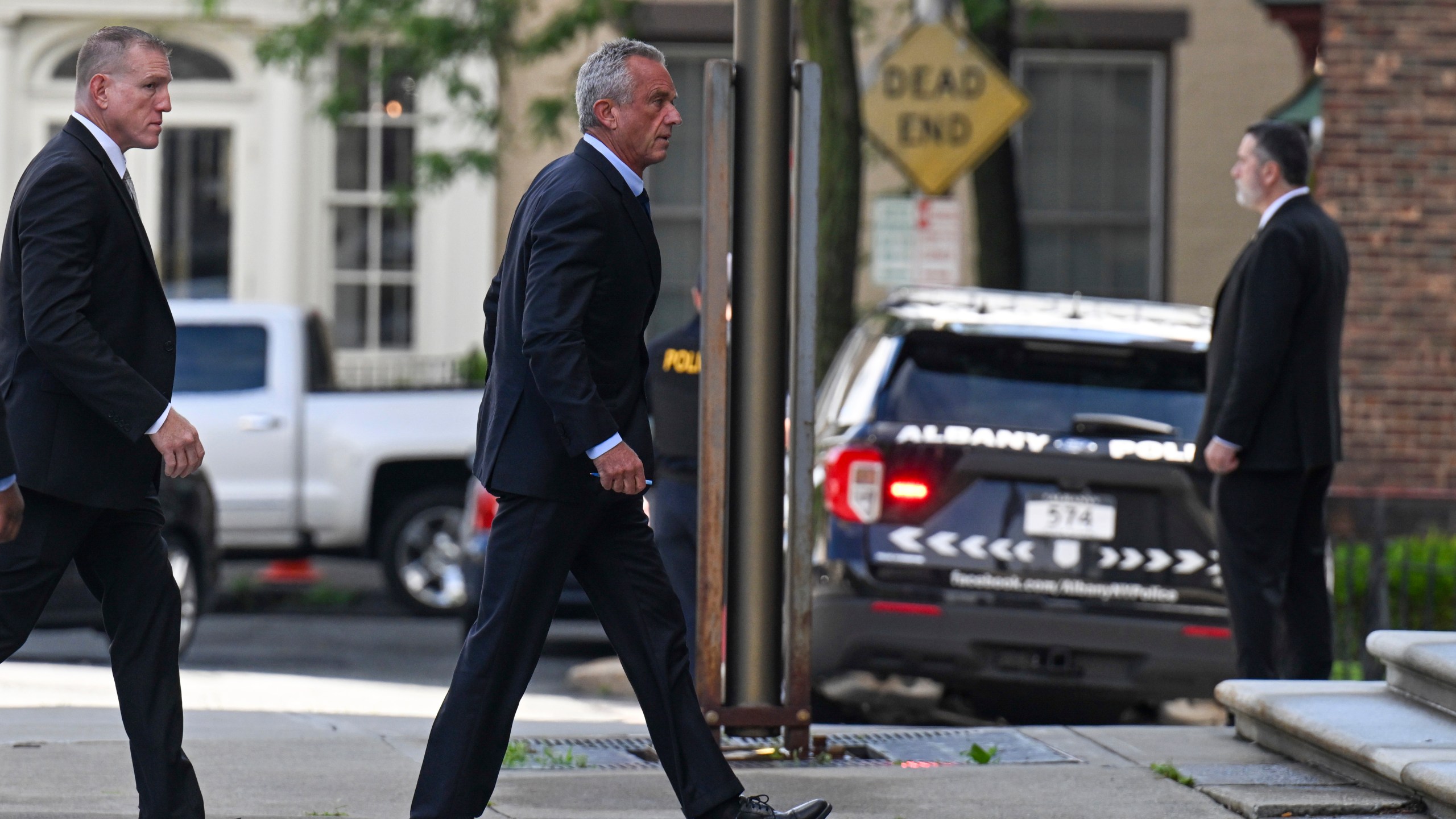 Independent presidential candidate Robert F. Kennedy Jr., right, arrives at the Albany County Courthouse to fight a lawsuit he falsely claimed to live in New York state, Wednesday, Aug. 7, 2024, in Albany, N.Y. (AP Photo/Hans Pennink)