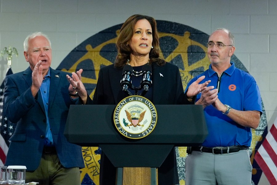 Democratic presidential nominee Vice President Kamala Harris, with Democratic vice presidential nominee Minnesota Gov. Tim Walz, left, and Shawn Fain, President of the UAW, right, speaks at a campaign rally at UAW Local 900, Thursday, August 8, 2024, in Wayne, Mich. (AP Photo/Julia Nikhinson)