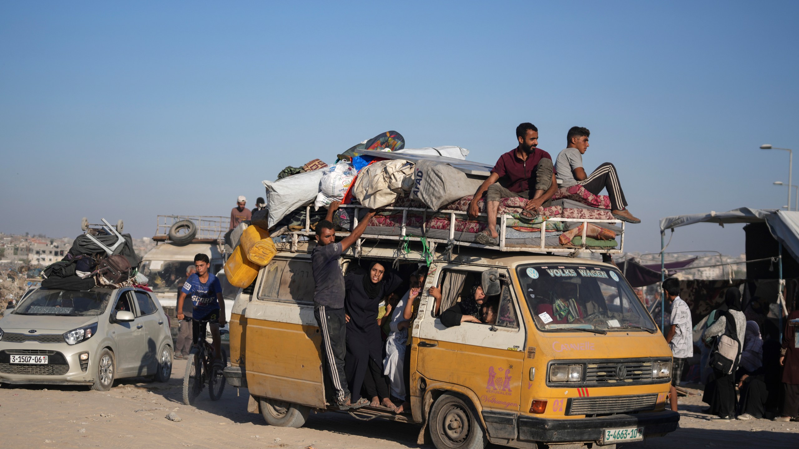 Palestinians flee the Khan Younis area of the Gaza Strip, following Israeli military evacuation orders, saying its forces will soon operate there, Thursday, Aug. 8, 2024. (AP Photo/Abdel Kareem Hana)