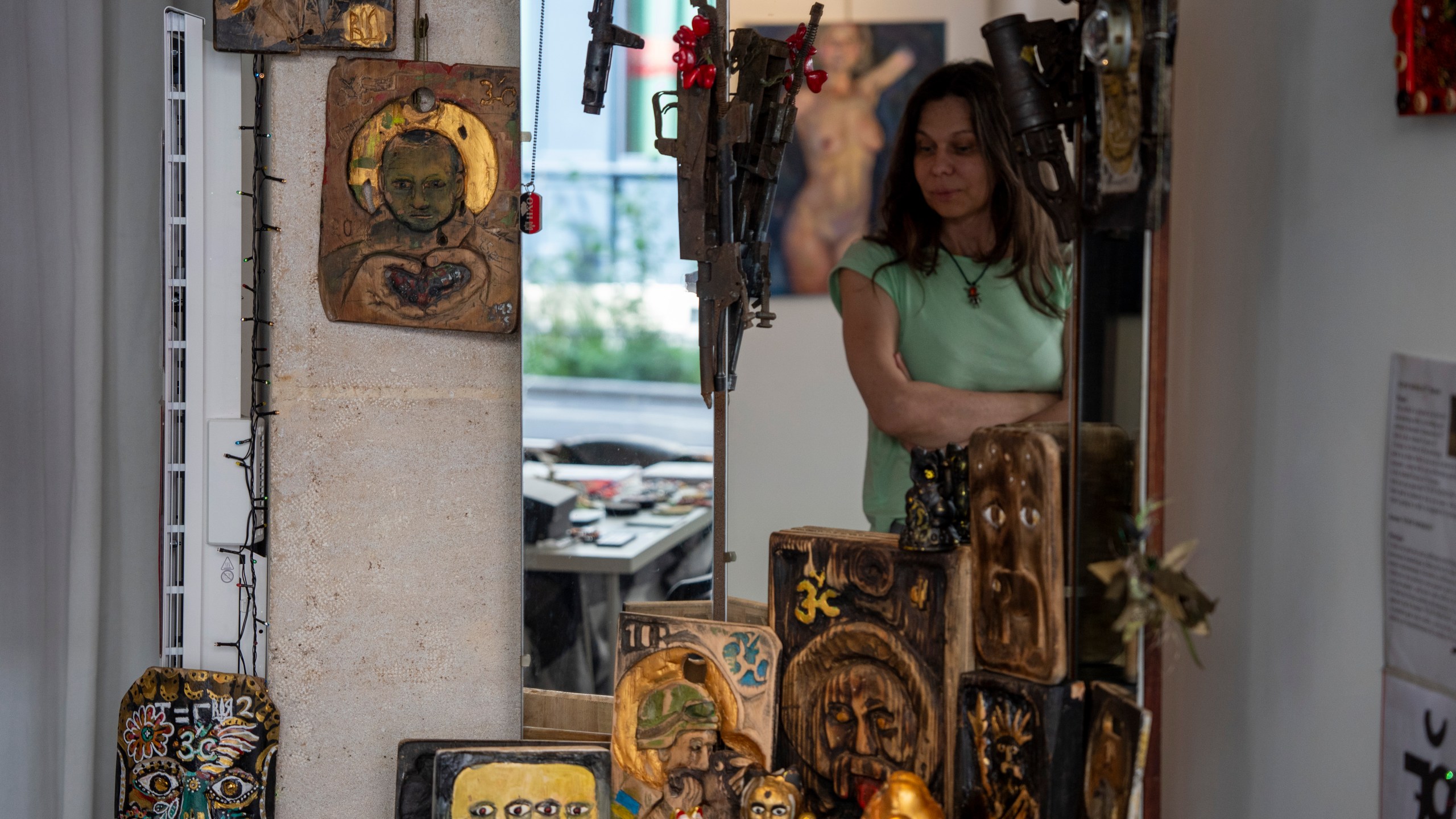 Lidiia Guzhva, a curator of the exhibition "A Snapshot in Time," looks at the art installation in Paris, France, Sunday, Aug. 4, 2024. (AP Photo/Hanna Arhirova)