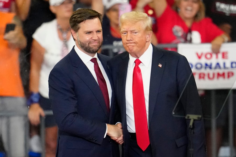 Republican vice presidential candidate Sen. JD Vance, R-Ohio, left, and Republican presidential candidate former President Donald Trump, shake hands at a campaign rally at Georgia State University in Atlanta, Saturday, Aug. 3, 2024. (AP Photo/Ben Gray)