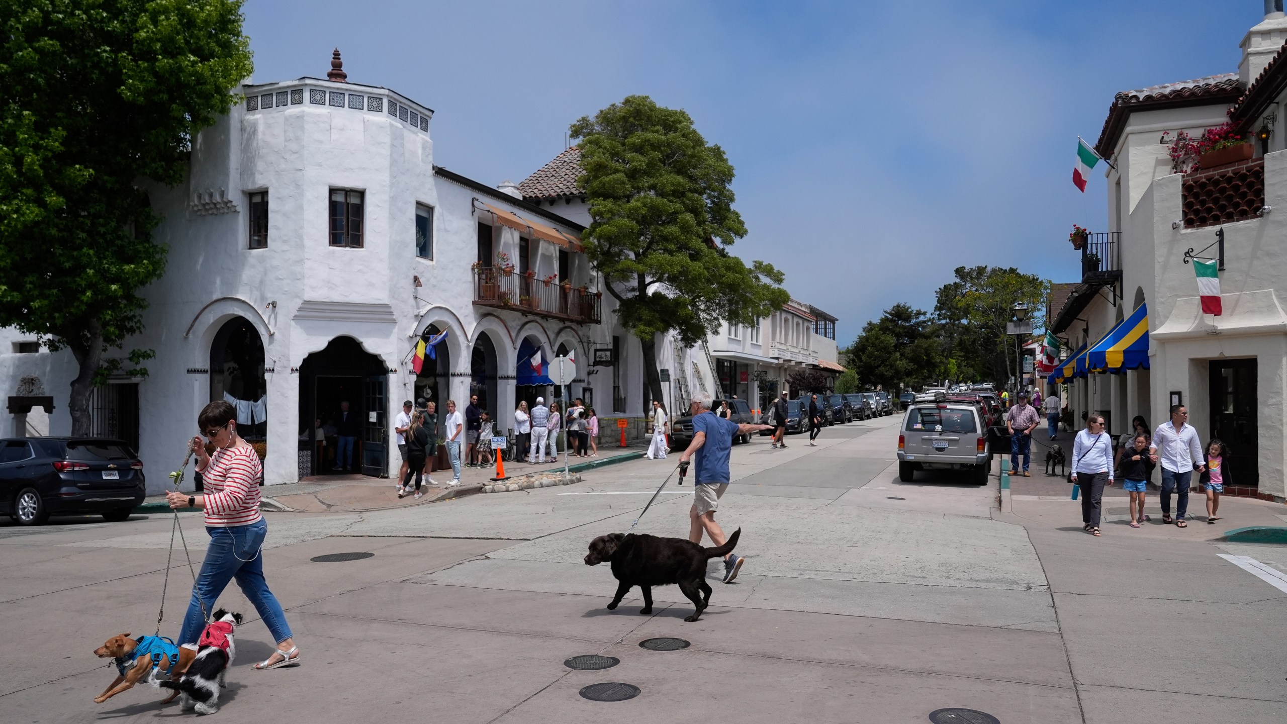 People visit Carmel-By-The-Sea, Calif., on Tuesday, July 23, 2024. (AP Photo/Godofredo A. Vásquez)