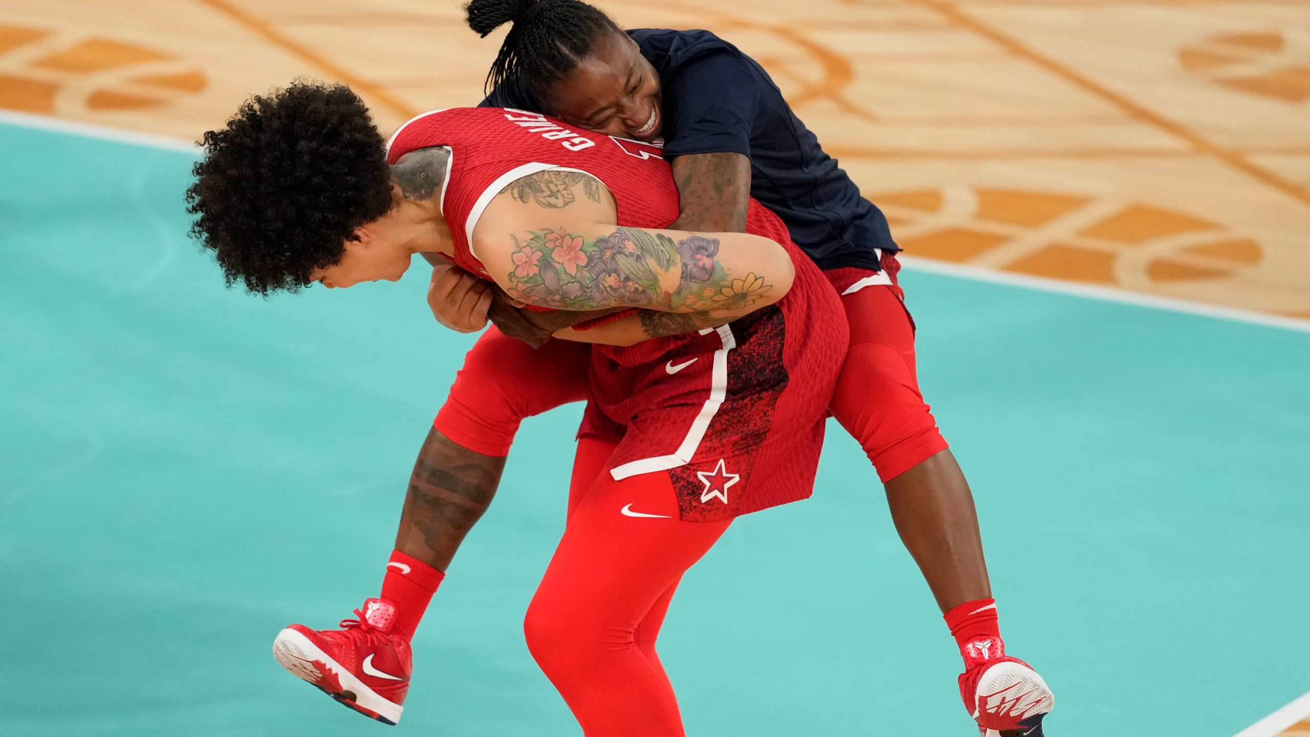 United States' Brittney Griner (15) and United States' Chelsea Gray (8) celebrate after a women's gold medal basketball game at Bercy Arena at the 2024 Summer Olympics, Sunday, Aug. 11, 2024, in Paris, France. (AP Photo/Michael Conroy)