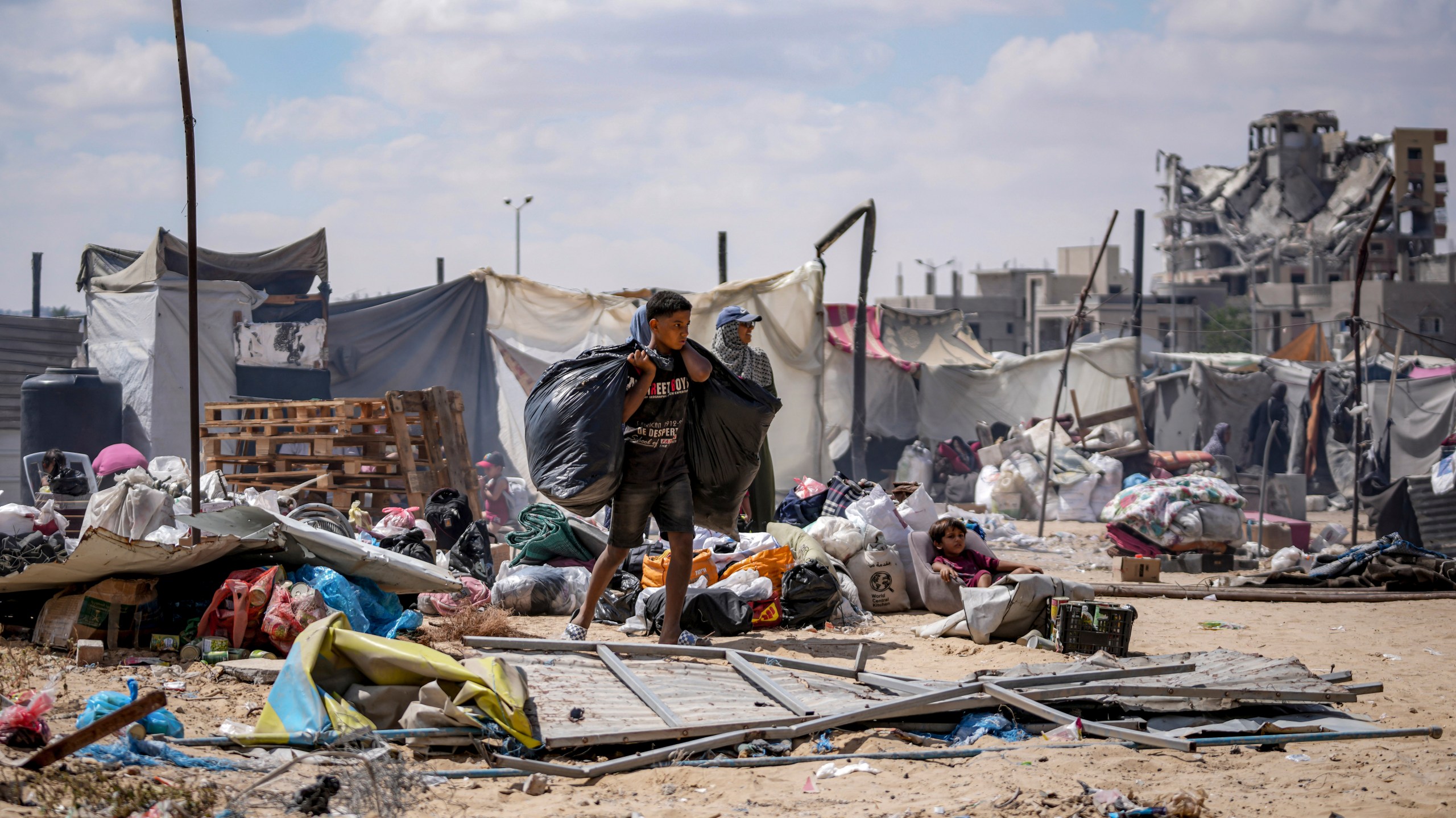 Palestinians displaced by the Israeli air and ground offensive on the Gaza Strip flee from Hamad City, following an evacuation order by the Israeli army to leave parts of the southern area of Khan Younis, Sunday, Aug. 11, 2024. (AP Photo/Abdel Kareem Hana)