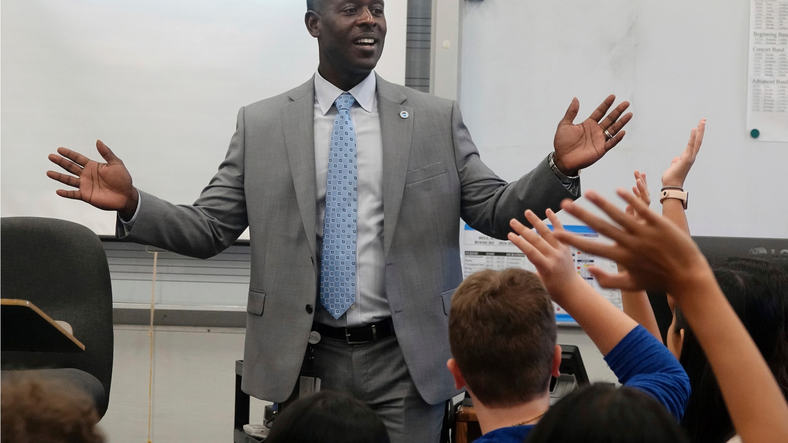 Broward County Superintendent Howard Hepburn greets students during the first day of school in Broward County at Pioneer Middle School in Cooper City, Fla., Monday, Aug. 12, 2024. (Joe Cavaretta/South Florida Sun-Sentinel via AP)