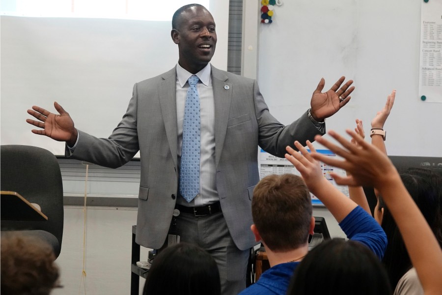 Broward County Superintendent Howard Hepburn greets students during the first day of school in Broward County at Pioneer Middle School in Cooper City, Fla., Monday, Aug. 12, 2024. (Joe Cavaretta/South Florida Sun-Sentinel via AP)