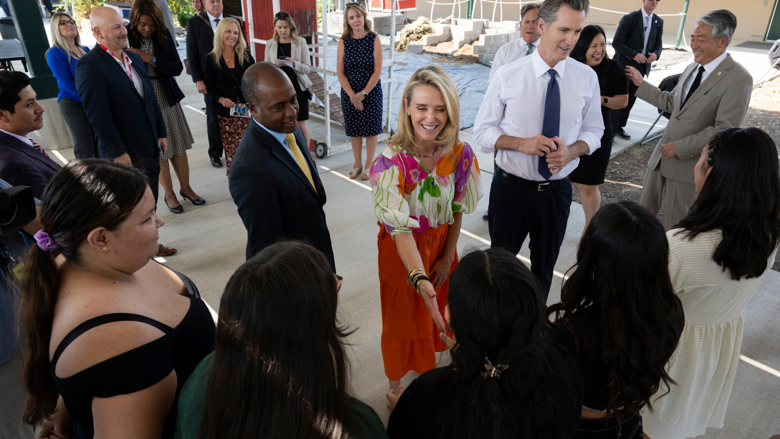 FILE - California First Partner Jennifer Siebel Newsom, center, greets a student while she stands with state Superintendent of Public Instruction Tony Thurmond and Gov. (Paul Kitagaki Jr./The Sacramento Bee via AP, Pool, File)