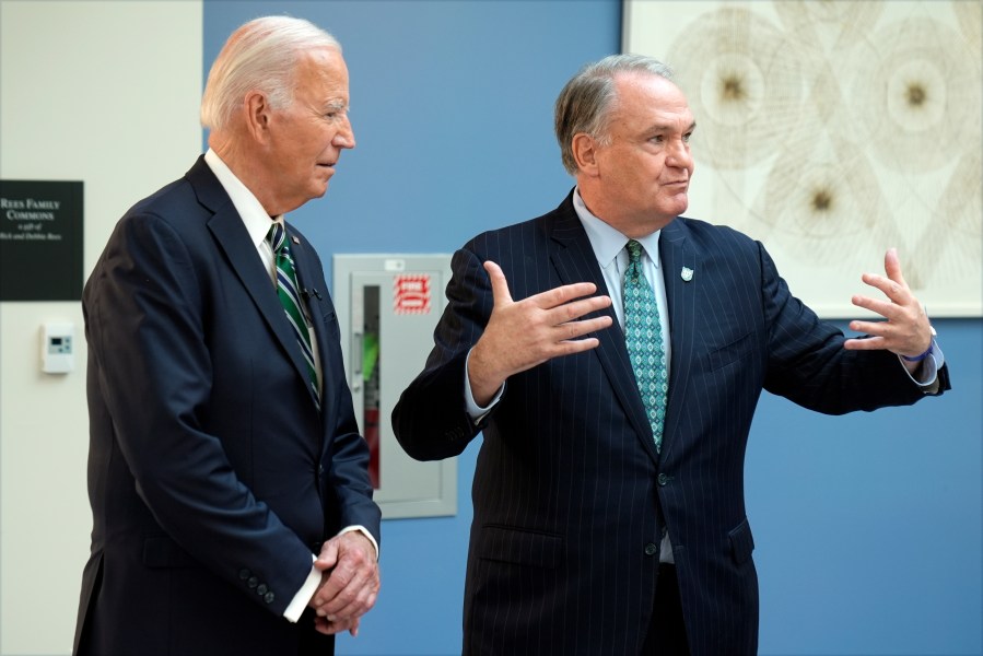 President Joe Biden listens as Tulane University President Michael Fitts speaks during a demonstration of cancer research and detection techniques at Tulane University, Tuesday, Aug. 13, 2024, in New Orleans. (AP Photo/Mark Schiefelbein)