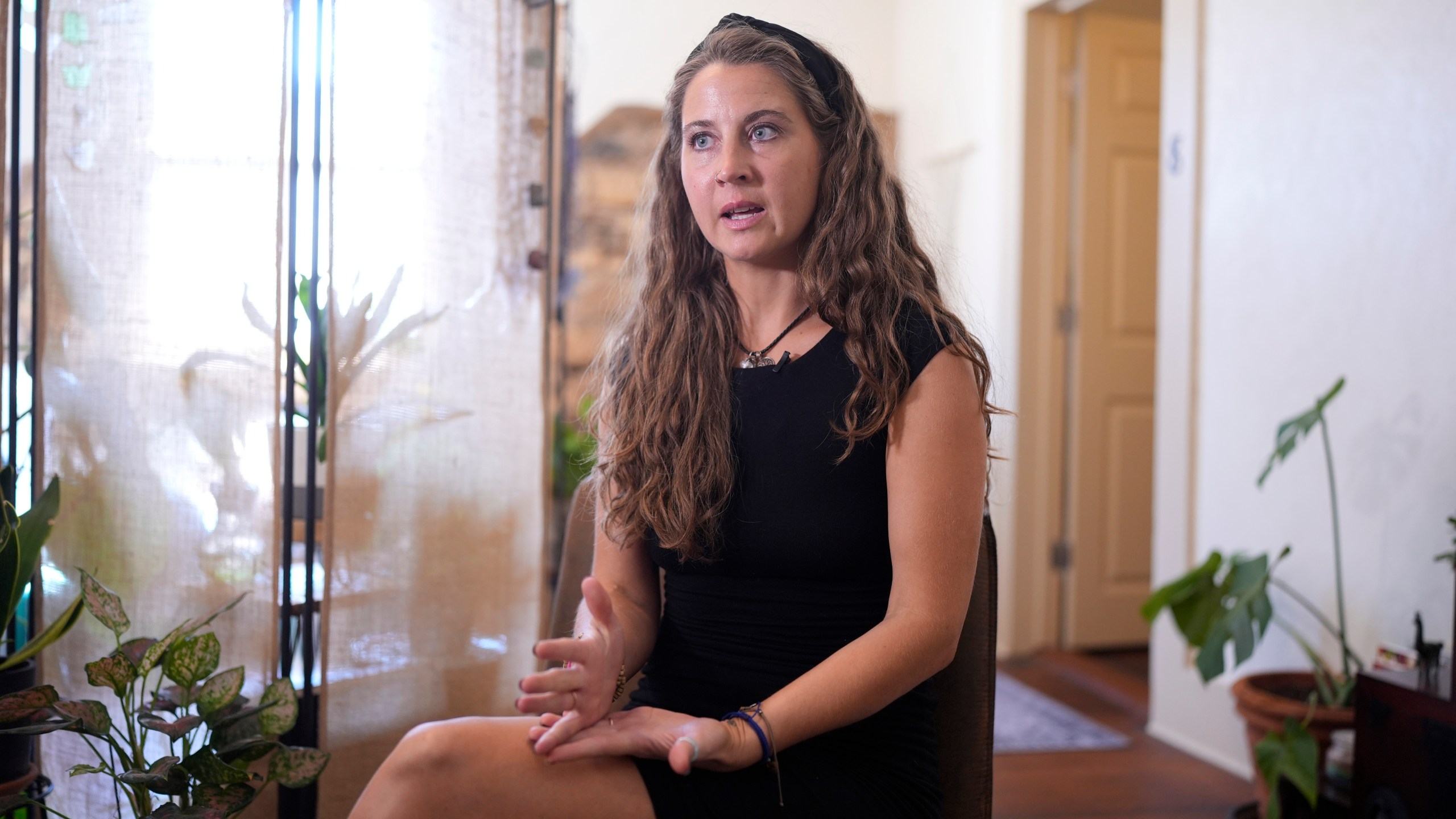 Kyleigh Thurman, one of the patients who is filing a federal complaint against an emergency room for not treating her ectopic pregnancy, talks about her experience at her studio, Wednesday, Aug. 7, 2024, in Burnet County, Texas. (AP Photo/Eric Gay)