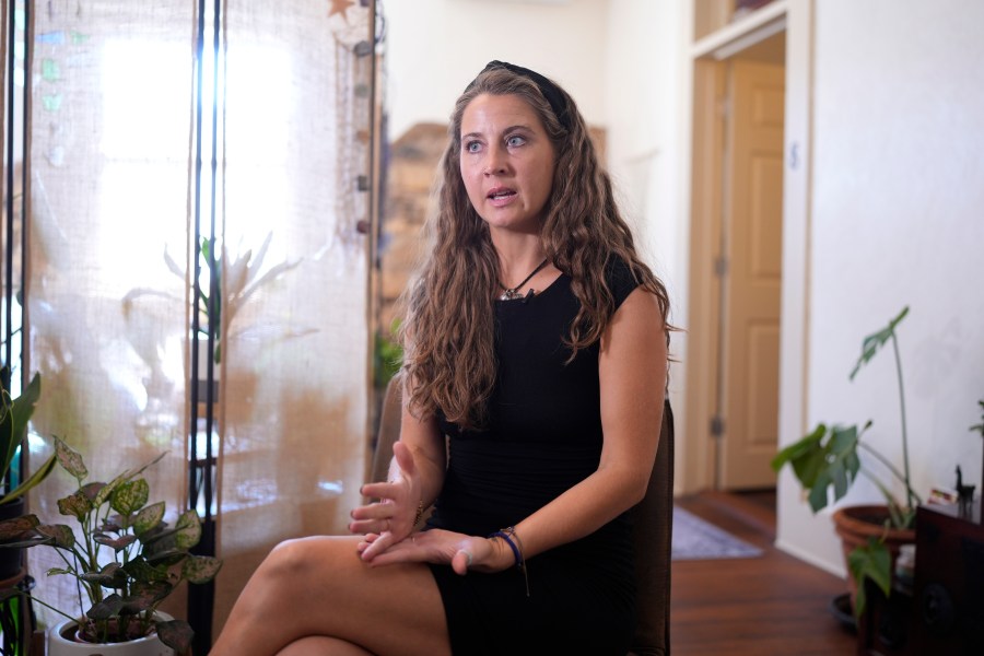 Kyleigh Thurman, one of the patients who is filing a federal complaint against an emergency room for not treating her ectopic pregnancy, talks about her experience at her studio, Wednesday, Aug. 7, 2024, in Burnet County, Texas. (AP Photo/Eric Gay)