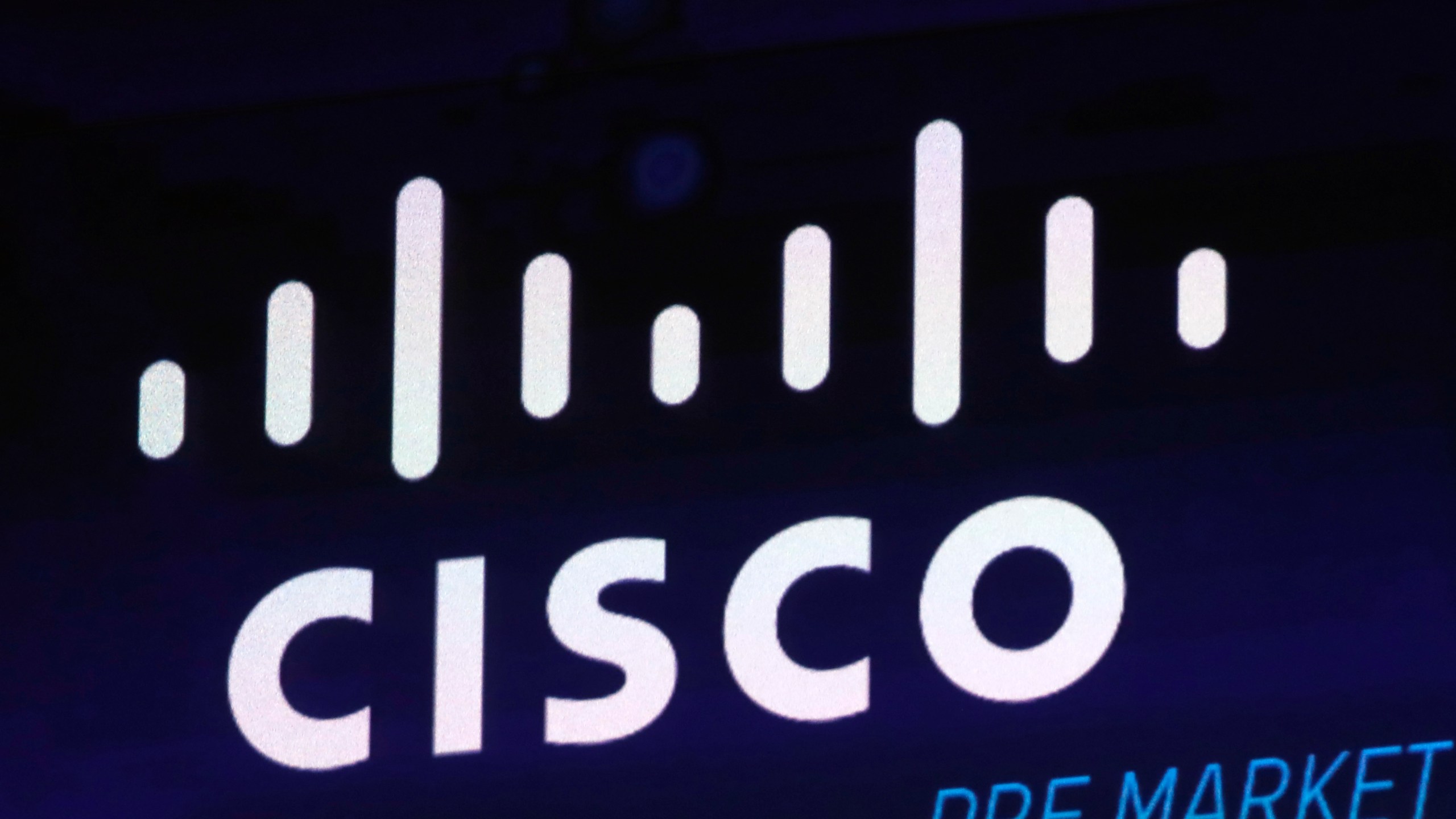 FILE - The Cisco logo appears on a screen at the Nasdaq MarketSite on Oct. 3, 2018 in New York's Times Square. (AP Photo/Richard Drew, File)