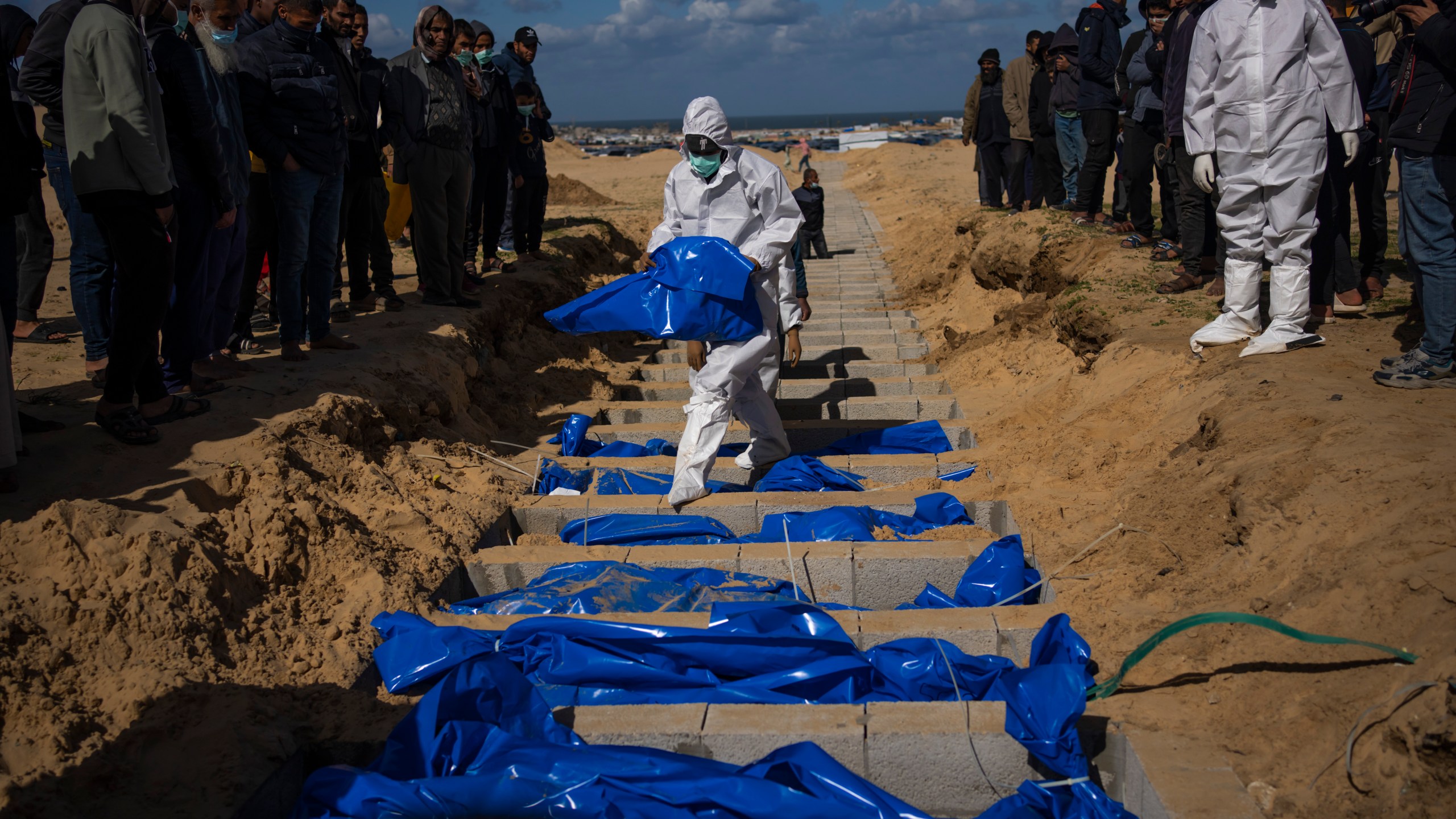 FILE - Palestinians bury the bodies of people who were killed in fighting with Israel and returned to Gaza by the Israeli military, during a mass funeral in Rafah, Gaza Strip, Tuesday, Jan. 30, 2024. (AP Photo/Fatima Shbair, File)